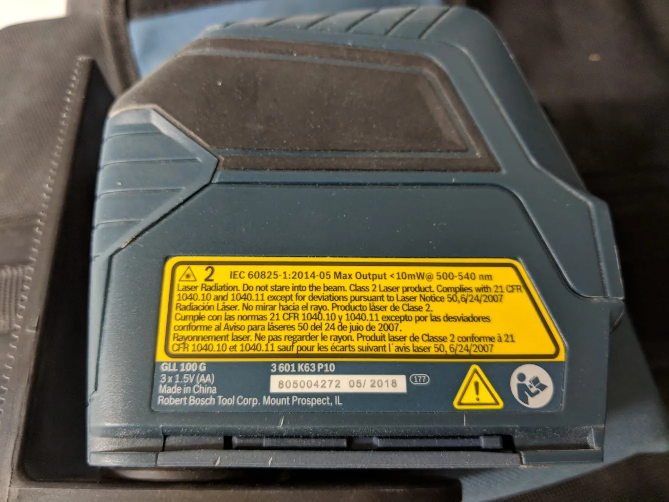 Rear label on Bosch GLL 100 GX showing model and three AA battery power
