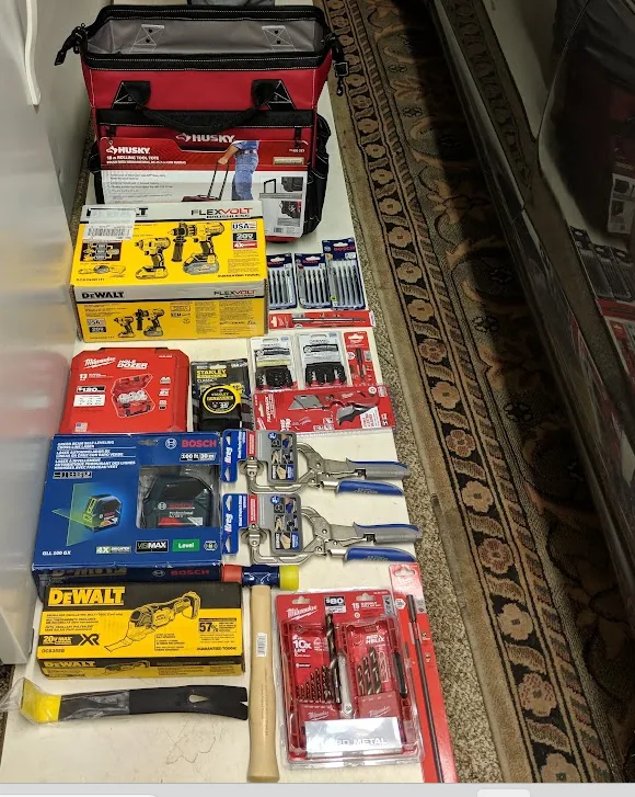 Bosch GLL 100 GX among a collection of professional carpentry tools