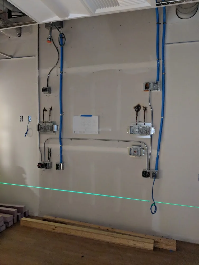 Bosch GLL 100 GX green horizontal laser line projected across a commercial interior wall