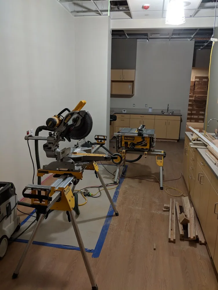 DEWALT jobsite miter saw and table saw used during real commercial carpentry work