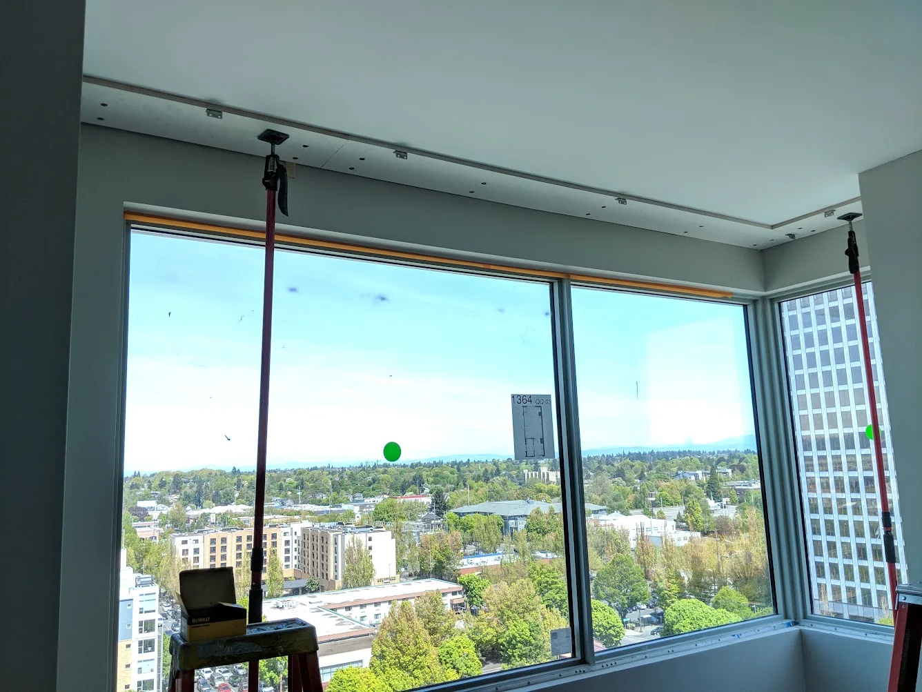 FastCap 3rd Hand support pole extended vertically in a large interior room