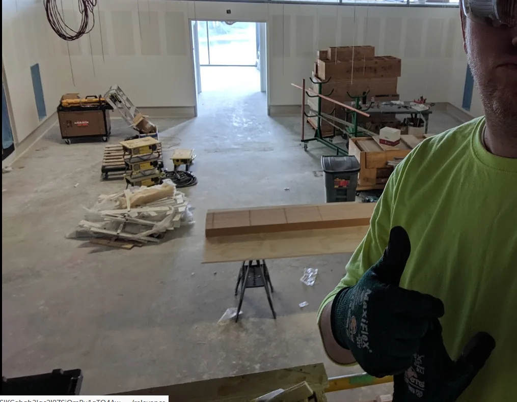 MaxiFlex work gloves being worn on a commercial carpentry jobsite