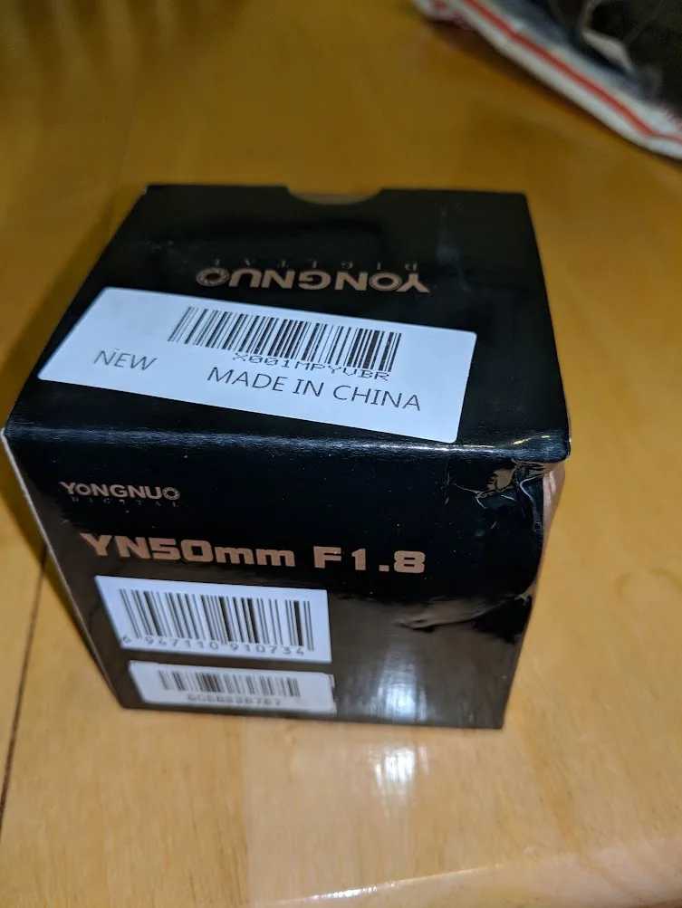 Box for the Yongnuo 50mm f/1.8 lens used in our home passport photo setup
